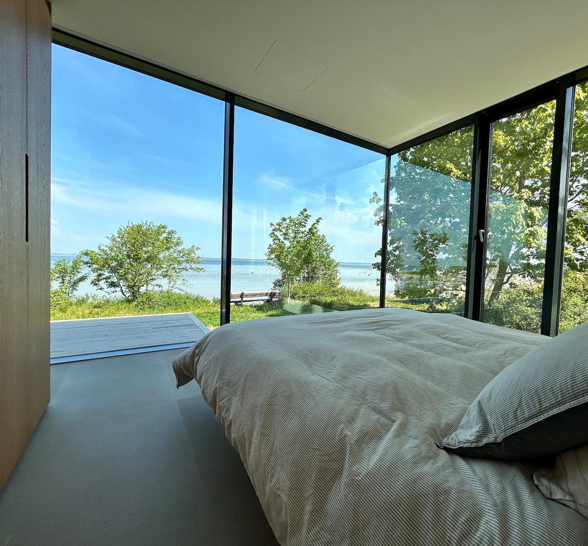 Signature bedroom with a summer view of the Baltic Sea